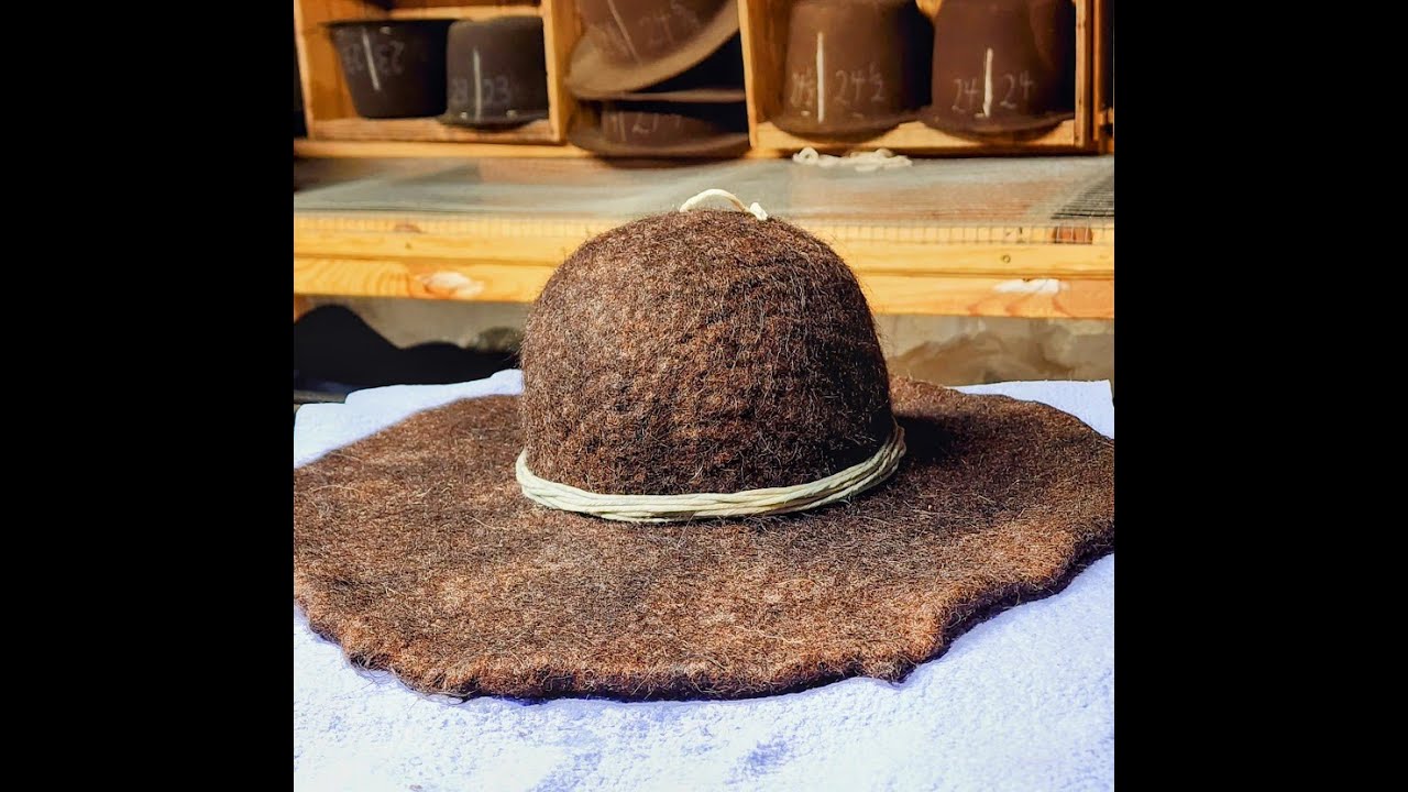 Legendary hatmaker, Lil Grizz, hand blocks a hat that he hand felted years ago.