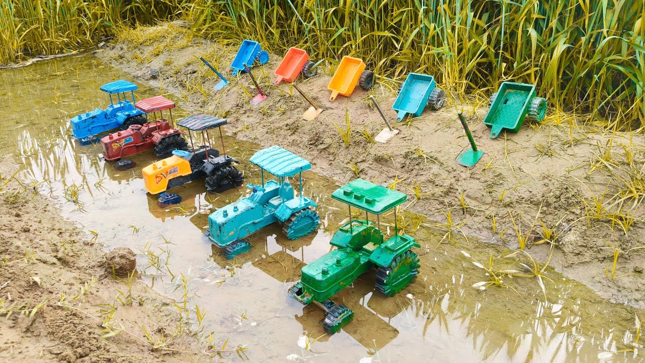 The group stood with their legs crossed and the tractor standing in the water in the field. 😲