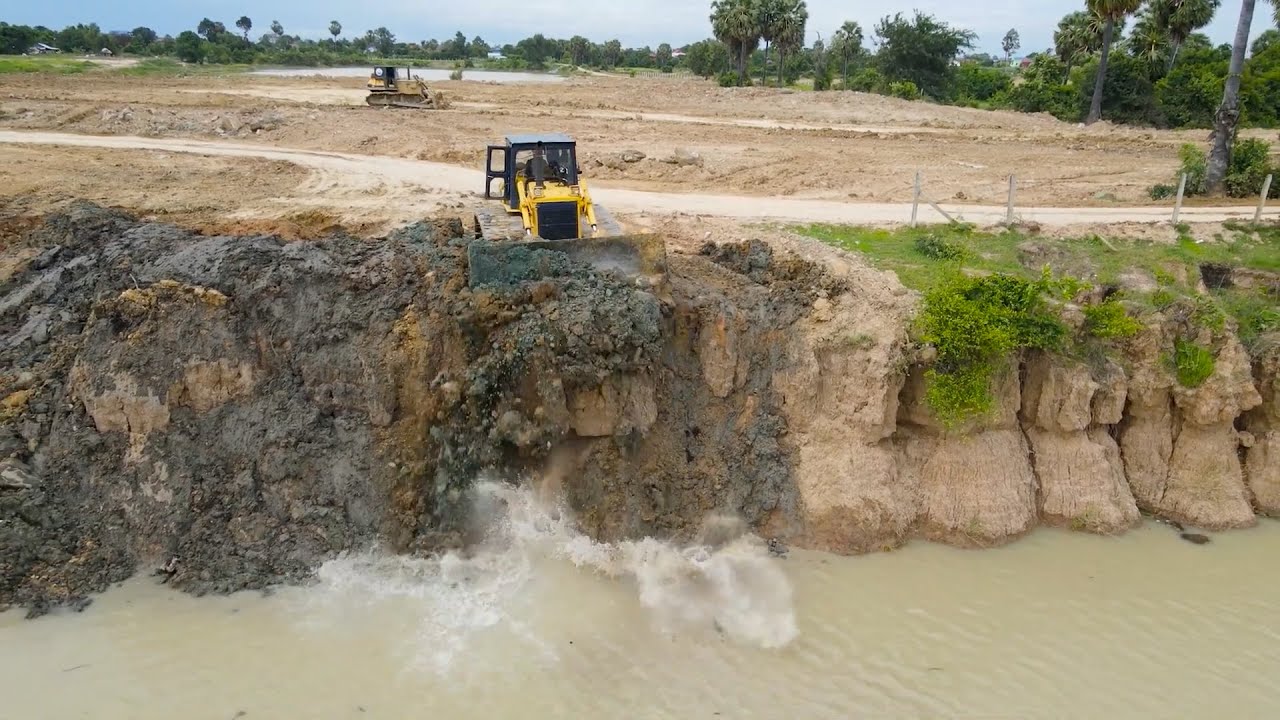 Best Action Two Bulldozer Pushing Soil and Mud in Water Clear Large Lake with Dump truck Unloading