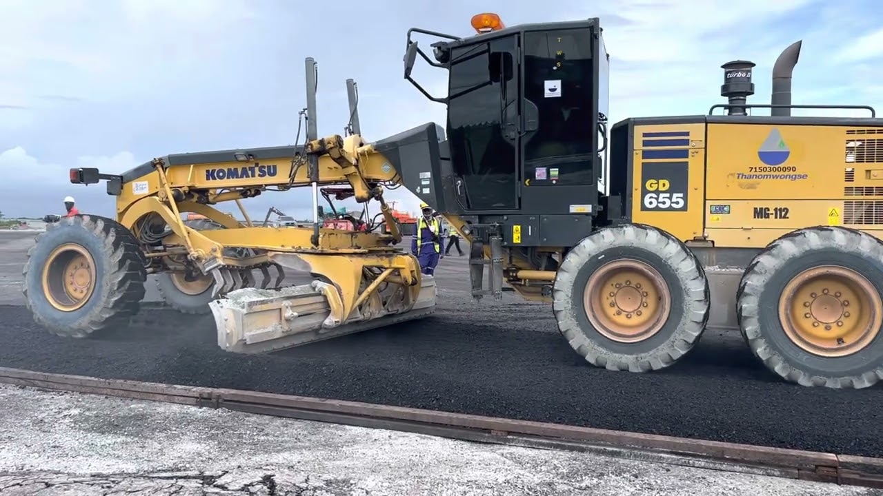 Komatsu motor grader laying asphalt.