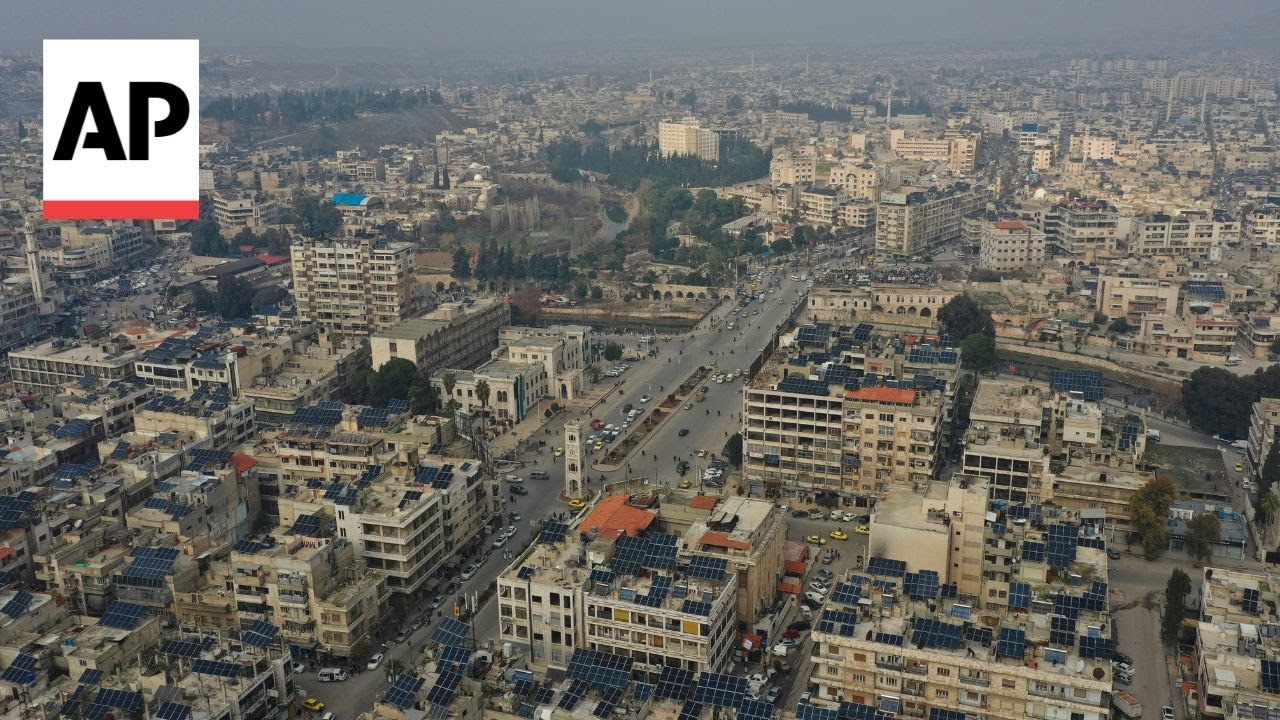 Aftermath of battle in Syrian city of Hama with charred tanks near mosque