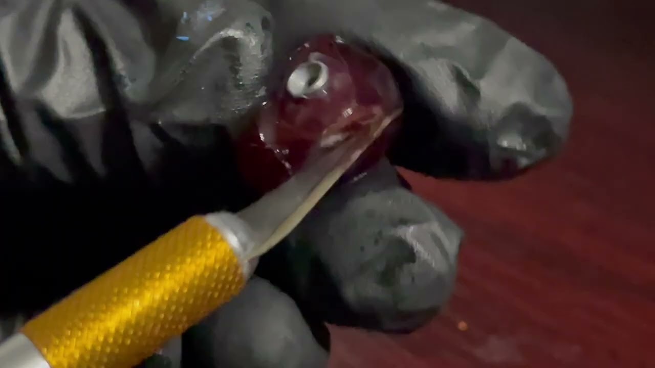 Preforming surgery on a grape.