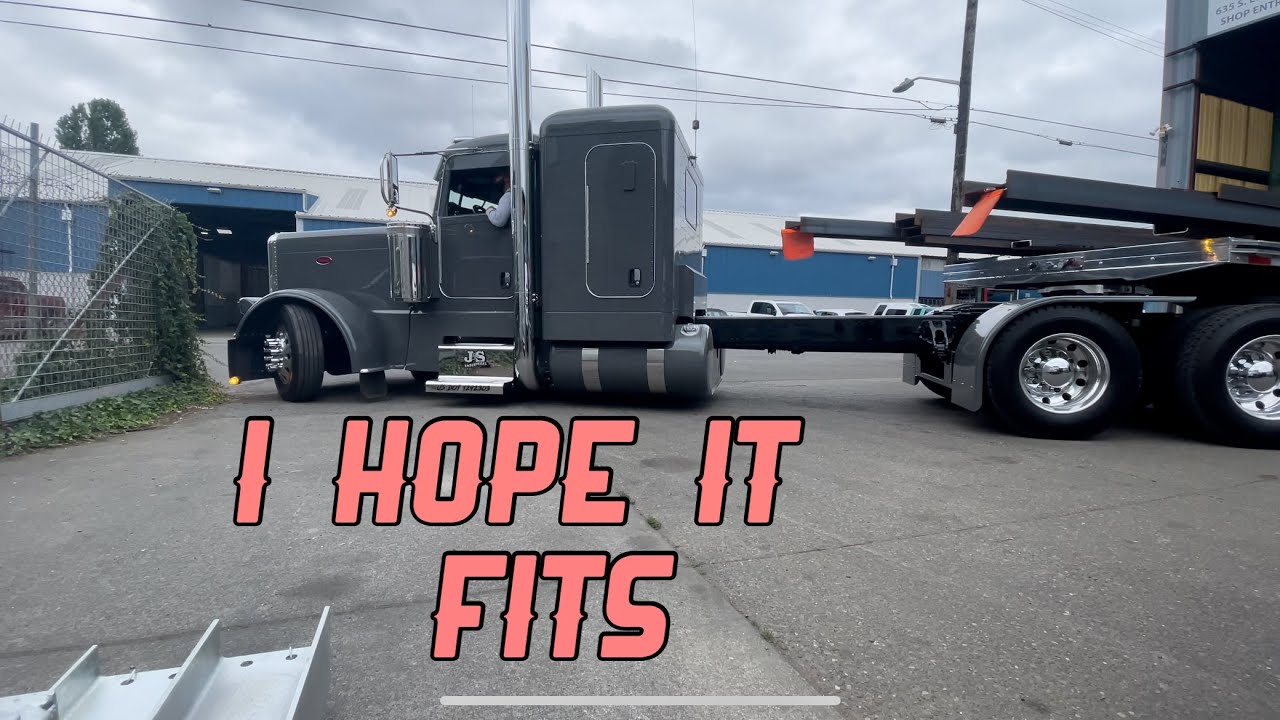 Stretched 2022 389 Peterbilt backing into tight Seattle shop with front overhanging steel beams