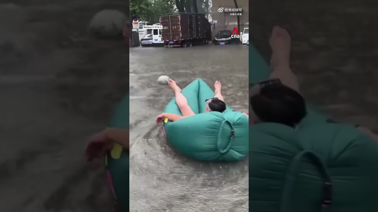 Chinese residents make the most of flooding with water sports, pet rafts