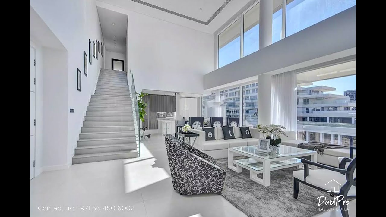 Inside a duplex Al Barari 2 bedroom apartment with double height ceiling