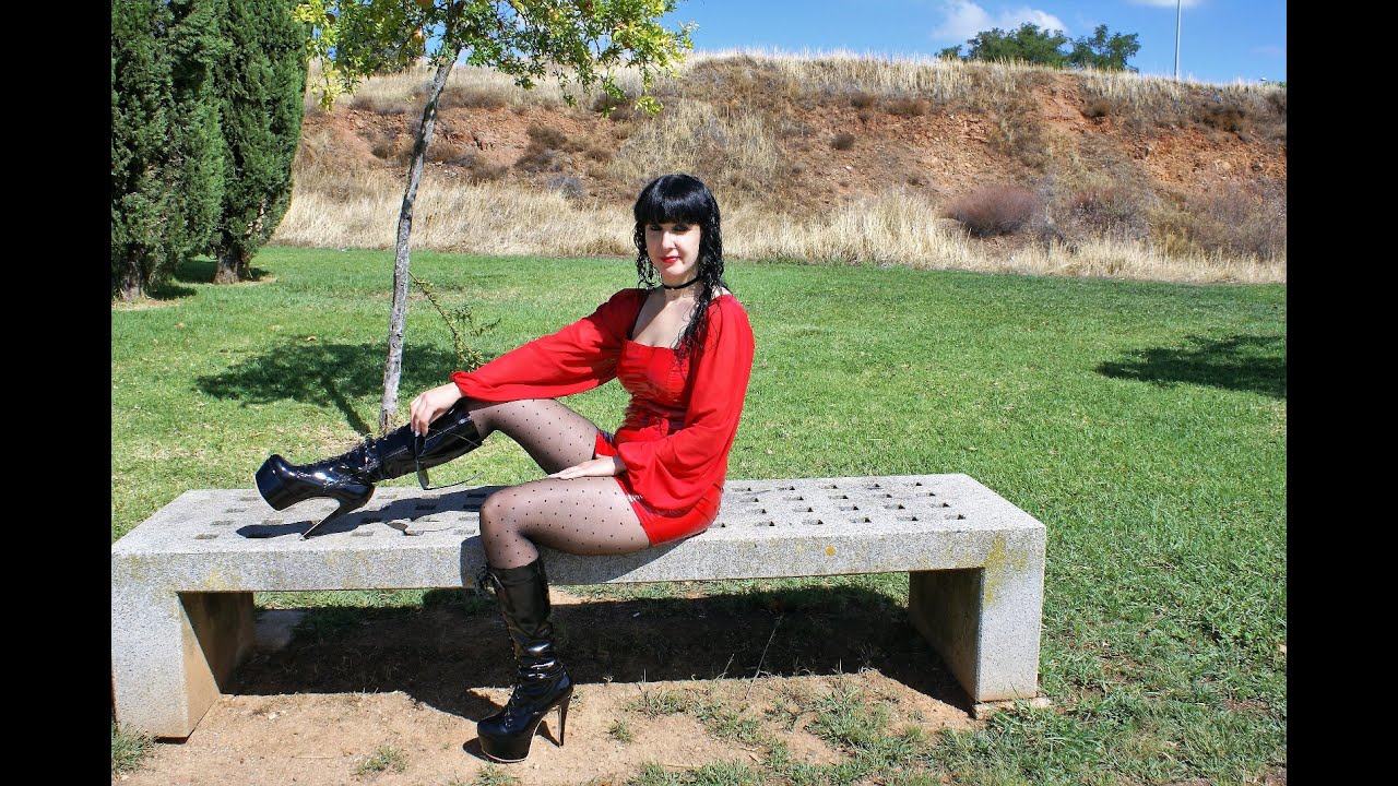Victoria Devil. Walking in a sexy red vinyl mini dress, black stockings and heeled boots 16cm.