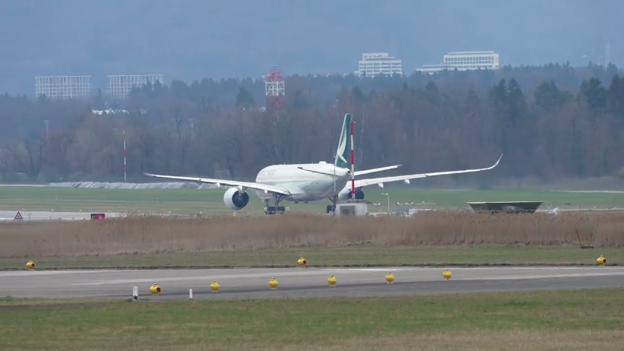 Zurich Airport Cathay Pacific airplane Airbus A350-941 B-LQH taking off on a winter day.