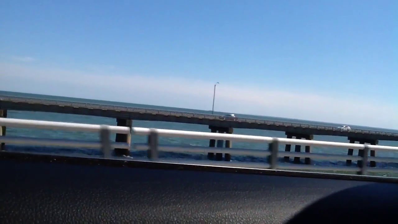 Riding in a car on a bridge with water