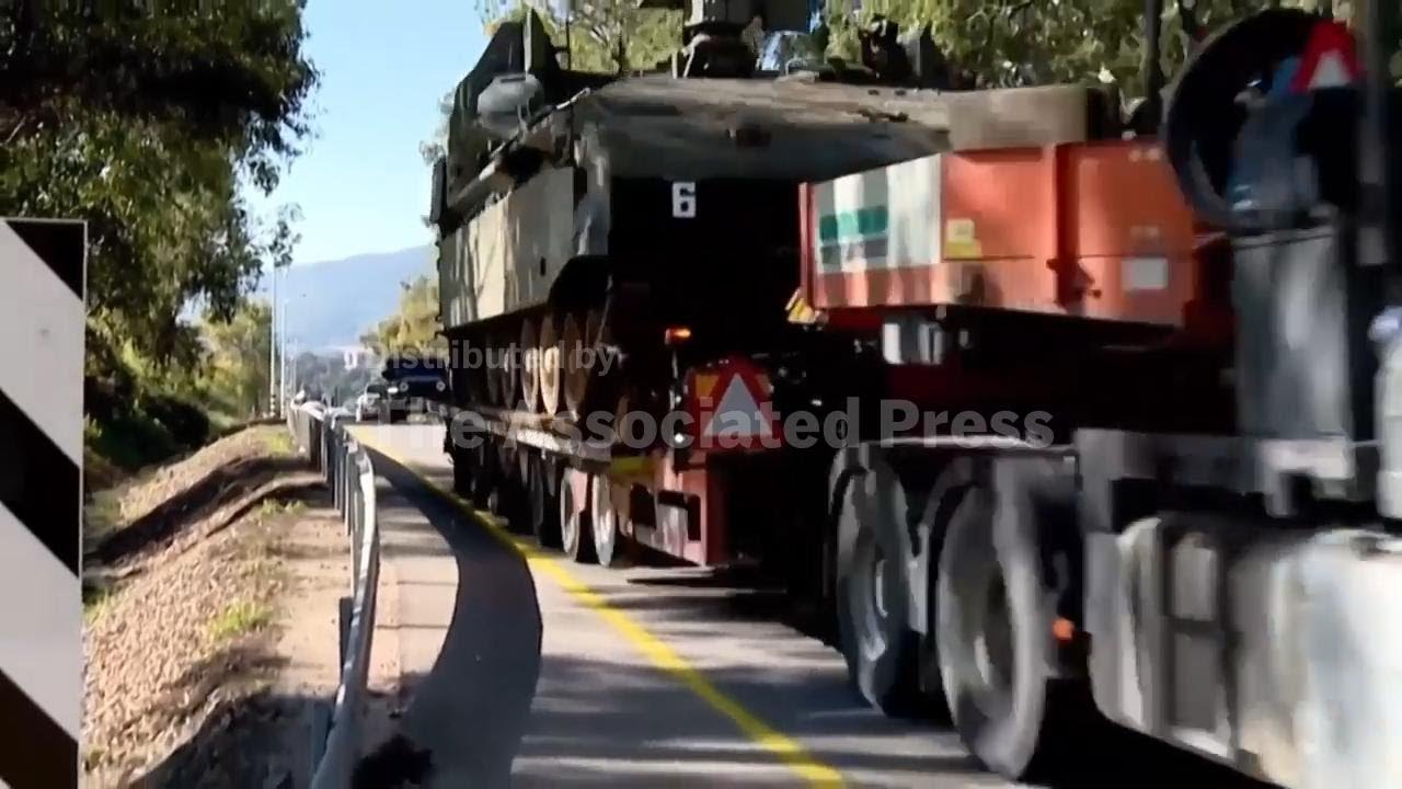 Israeli tanks move to Lebanon border as fighting escalates