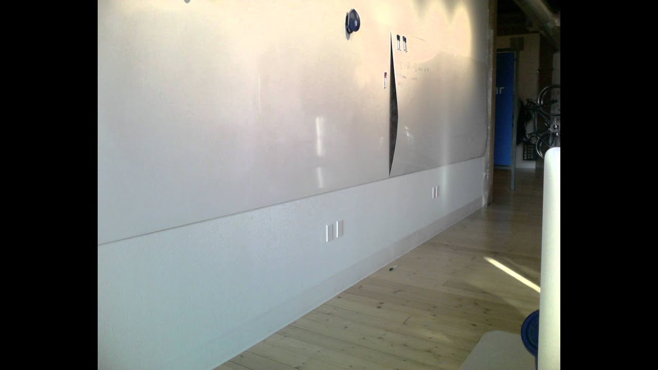 Time-lapse of whiteboard peeling off wall