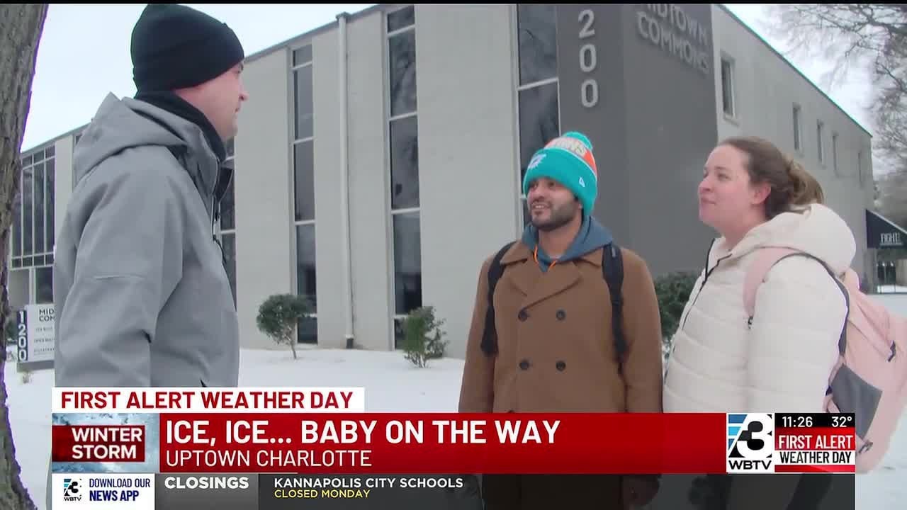 Couple walking in Uptown to Charlotte hospital