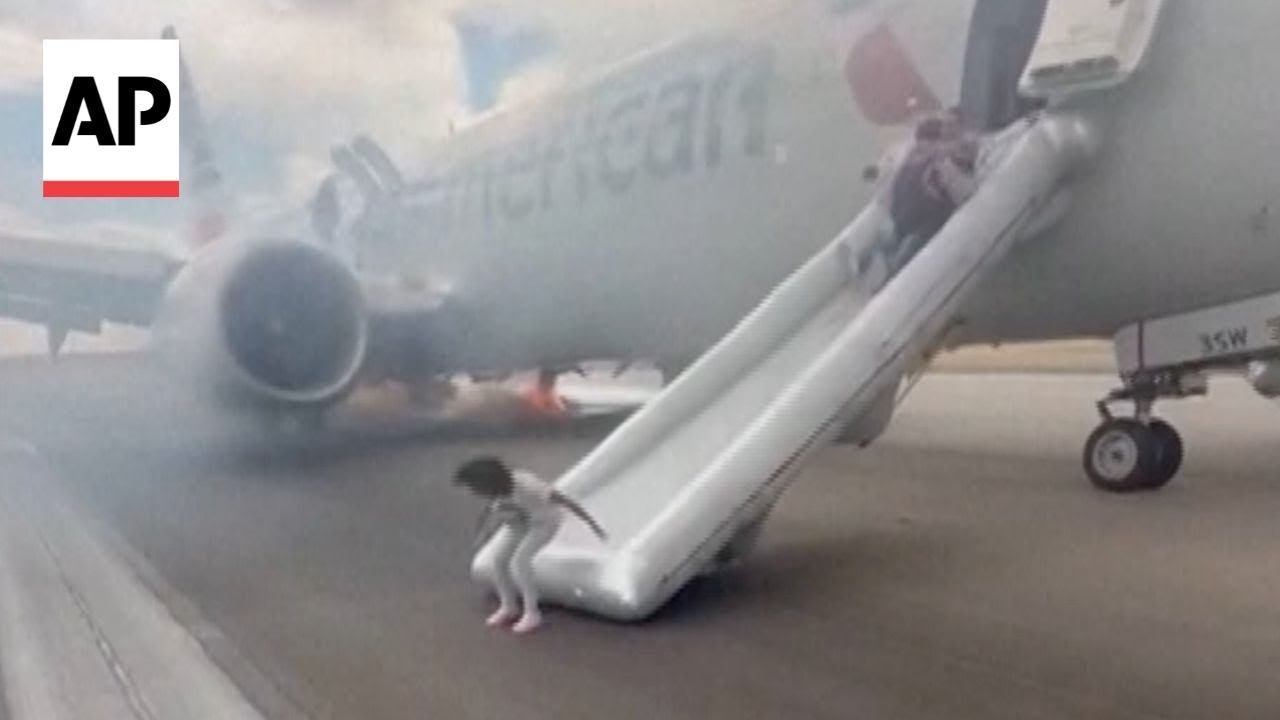 Passengers flee smoking jet on emergency slide at Denver airport