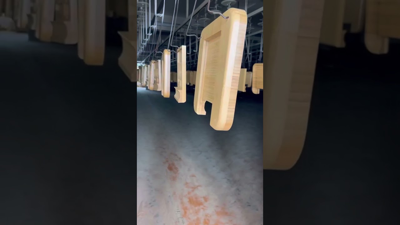 Bamboo cheese board being painted at the factory 