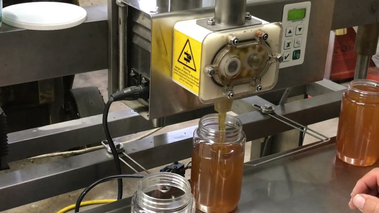 Filling honey jars the easy way.