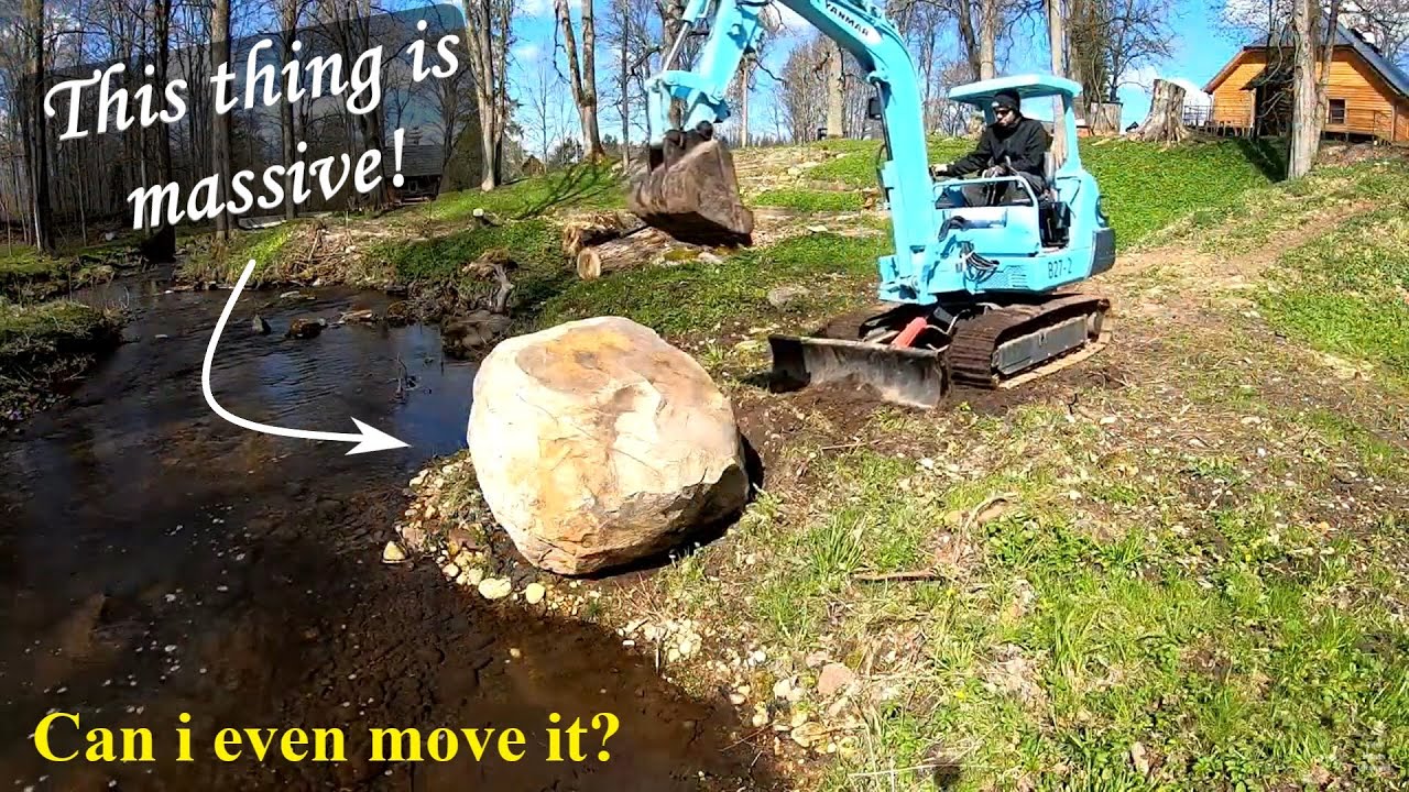 Moving a big boulder with a mini excavator