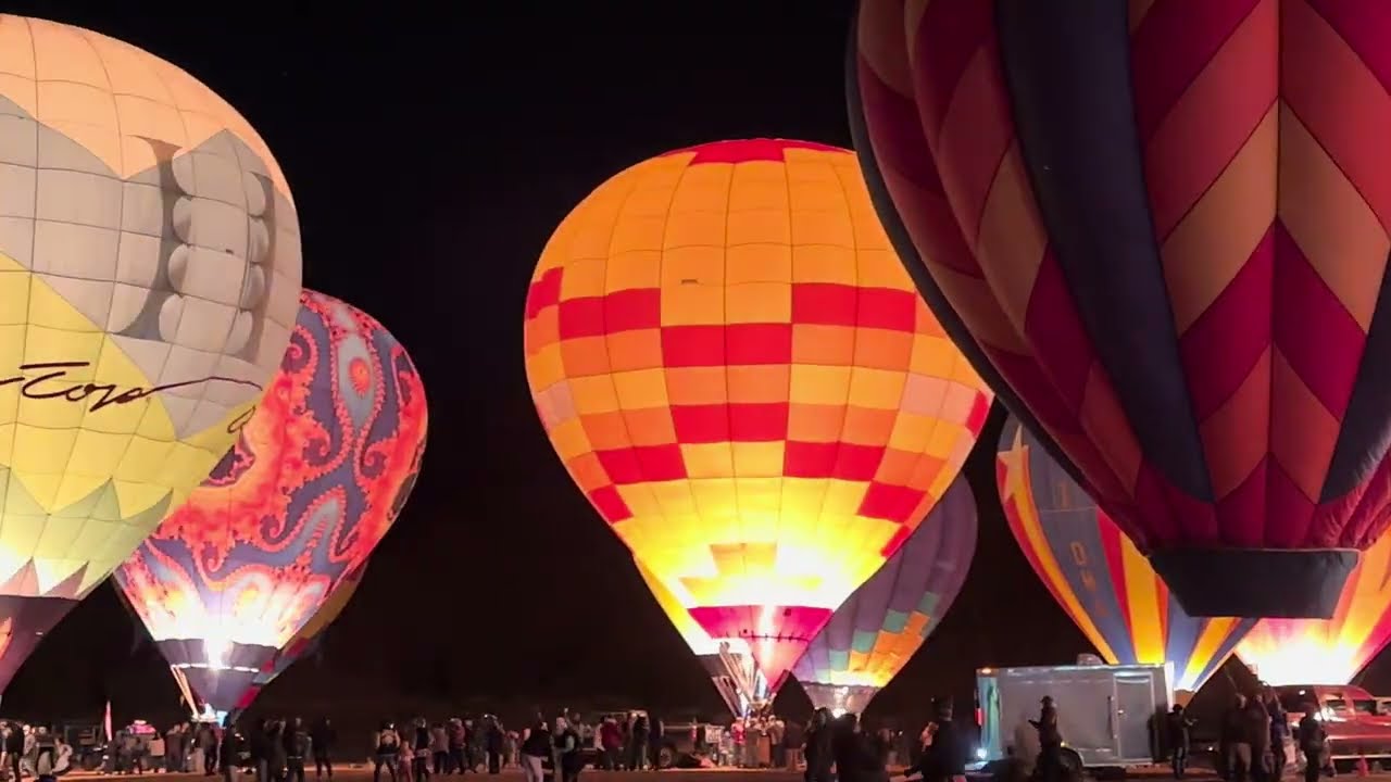 Colorful hot air balloons at the night balloon glow