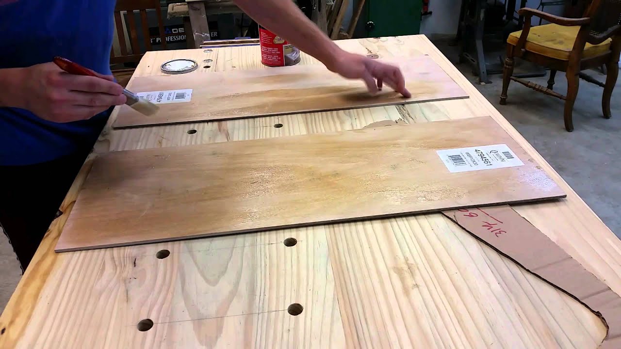Installing cabinet panels with contact cement.