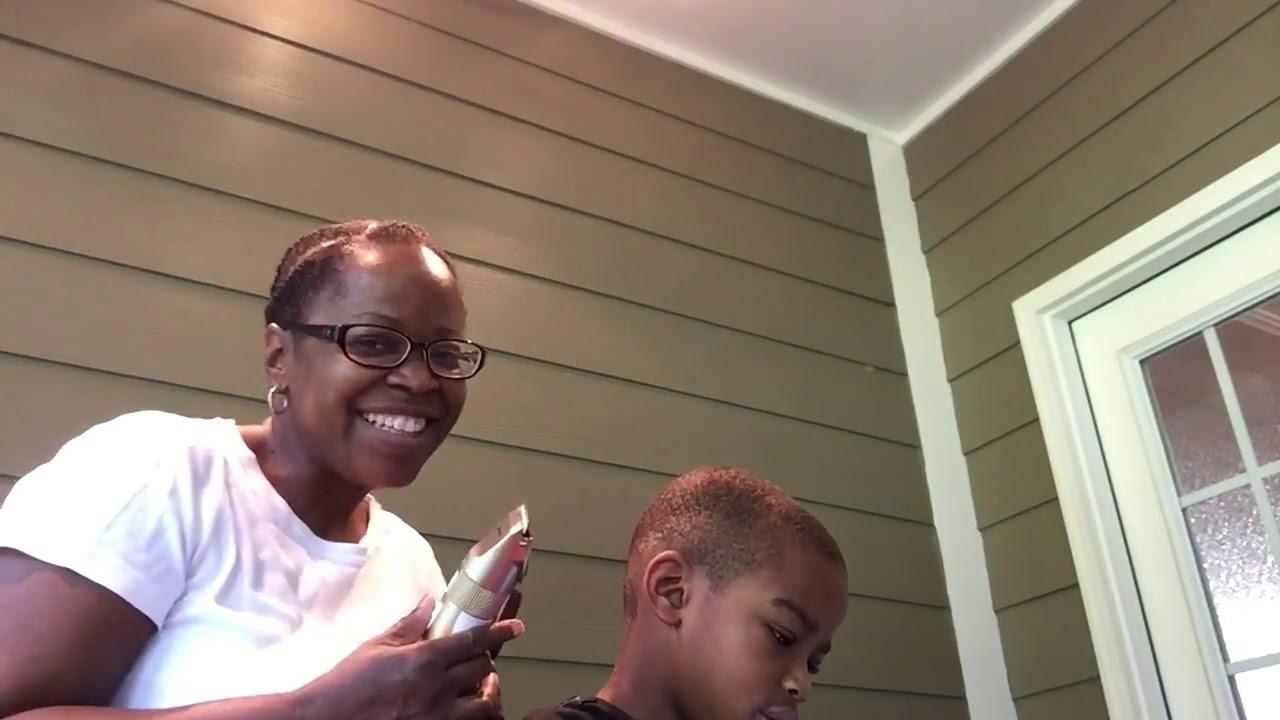 Mom cutting son’s hair