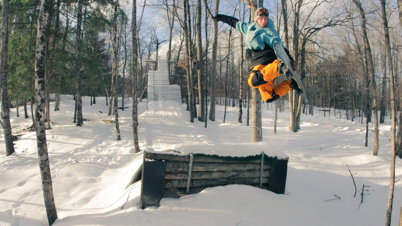 Snowboarding at a DIY snowboard jump with a 20 foot tall drop in ramp!