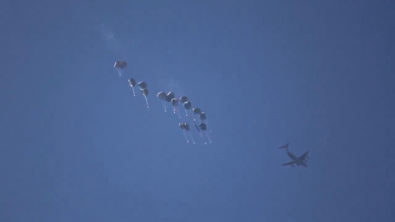 Hundreds gather in the beach south Gaza Strip trying to get aid airdropped in the enclave