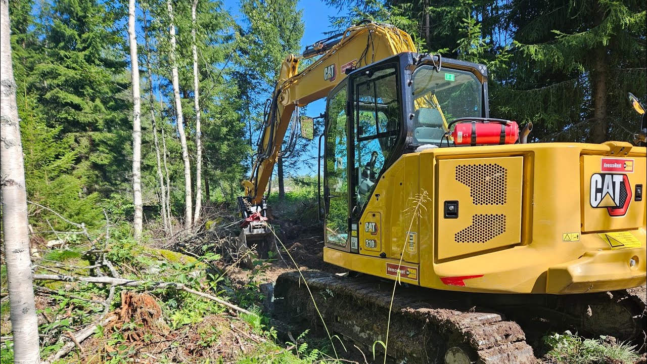 caterpillar 310 forest road clearing