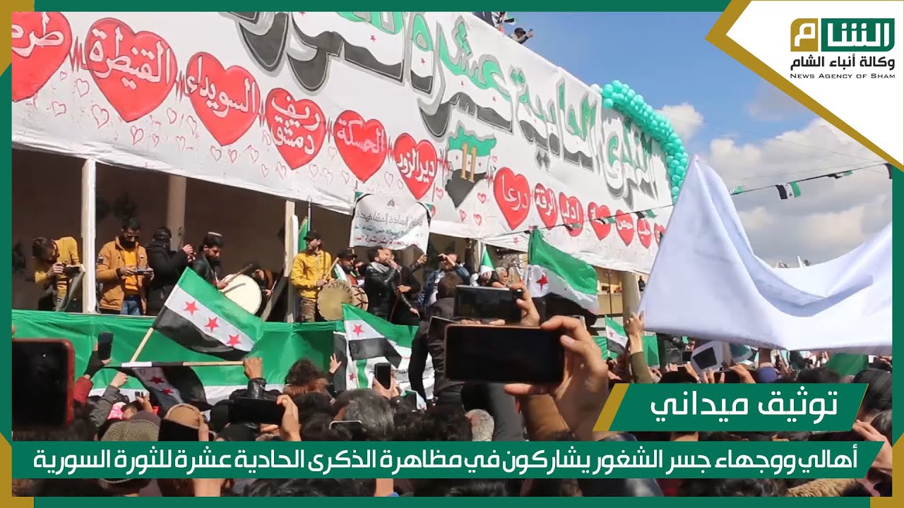 أهالي ووجهاء جسر الشغور يشاركون في مظاهرة الذكرى الحادية عشرة للثورة السورية.