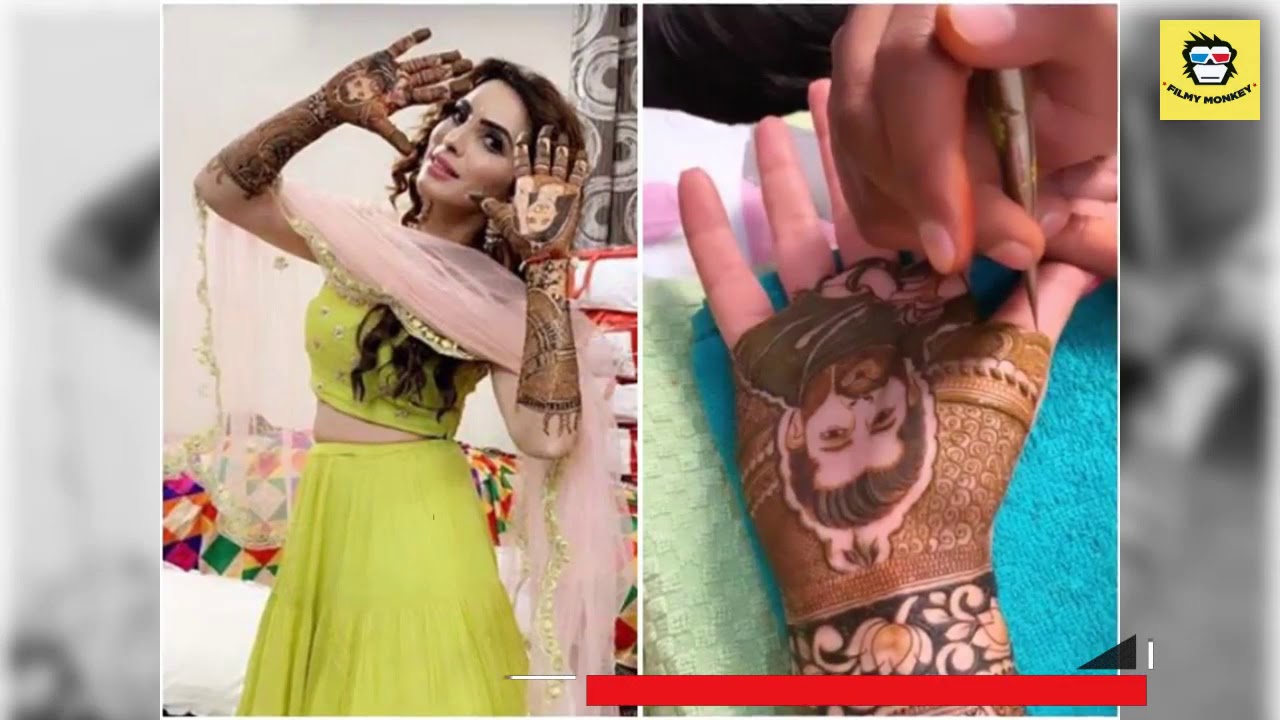 Mansi Sharma gets beau Yuvraj Hans' face drawn with henna on her hand during mehendi