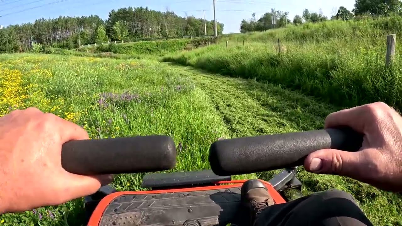 Kubota 0 turn mowing at the gun club..Wicked scary steep hill.. Super thick material to cut