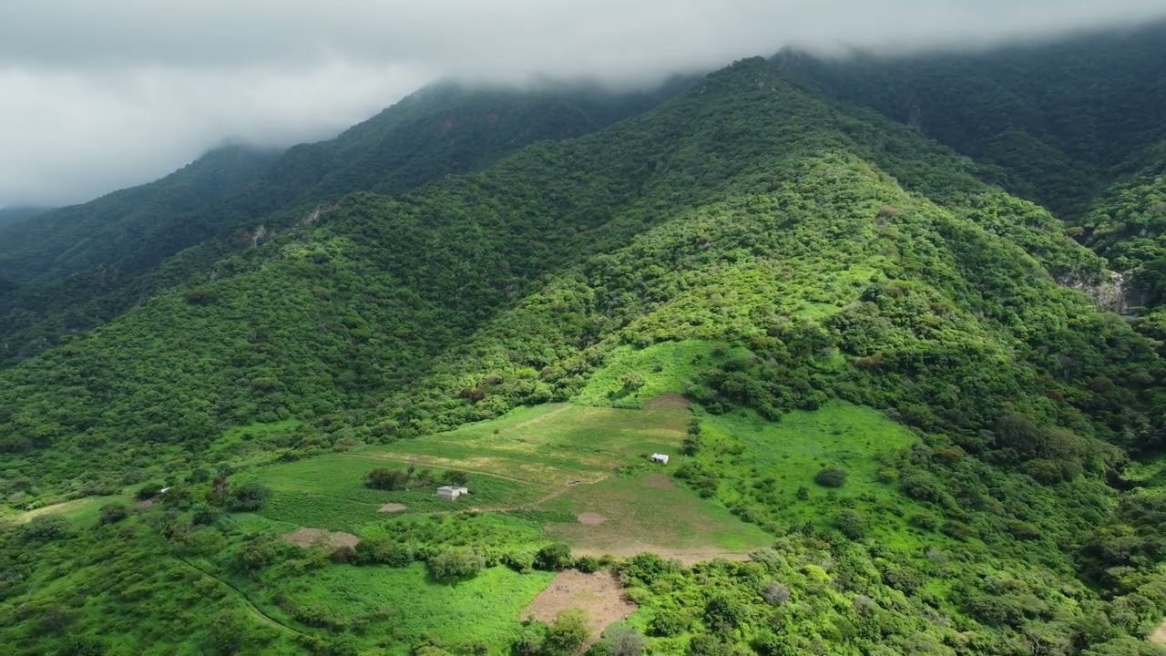 Lush Green Mountains Under Cloudy Skies 4K