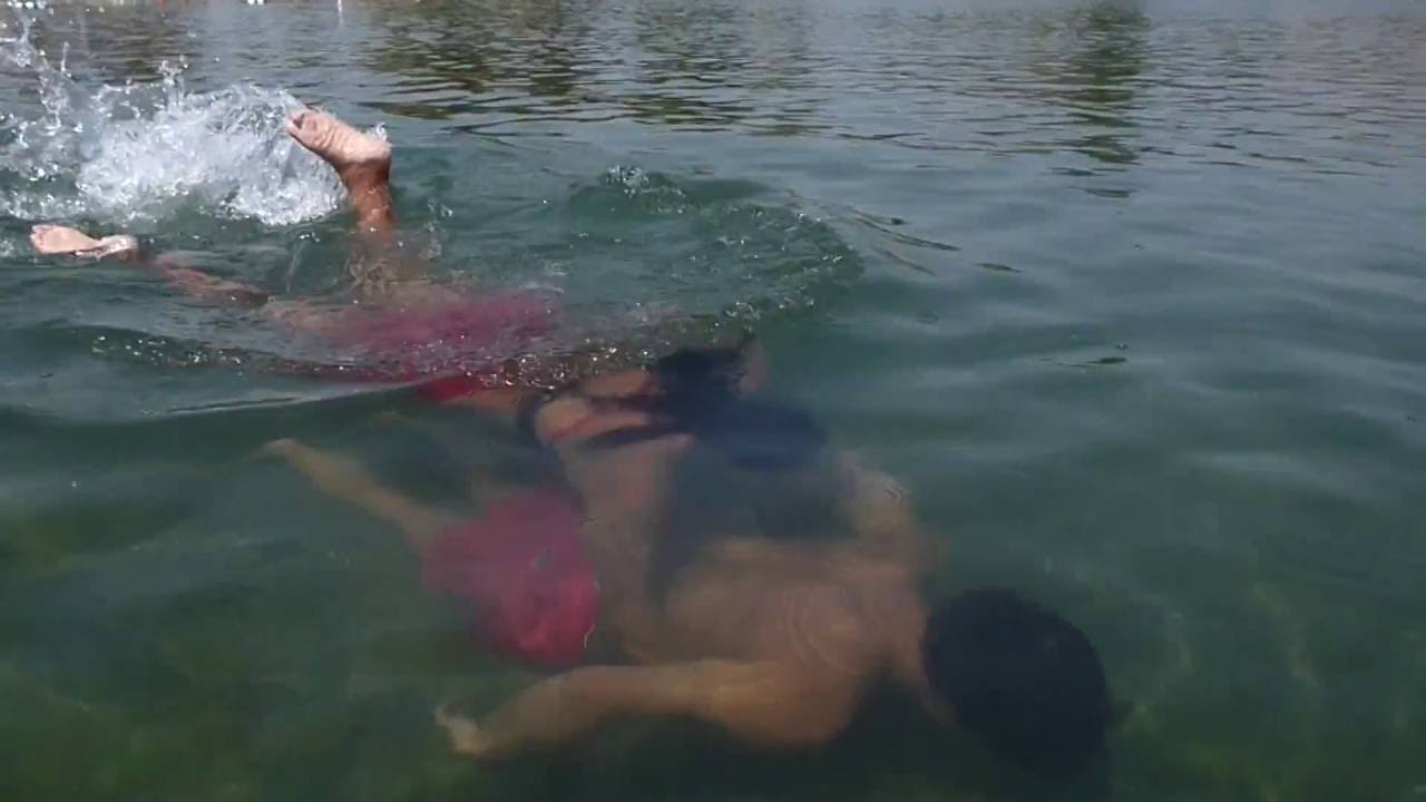 Lifeguarding Drill: Flatwater Rescue Tutorial, Mid-depth rescue tube trailing submerged victim