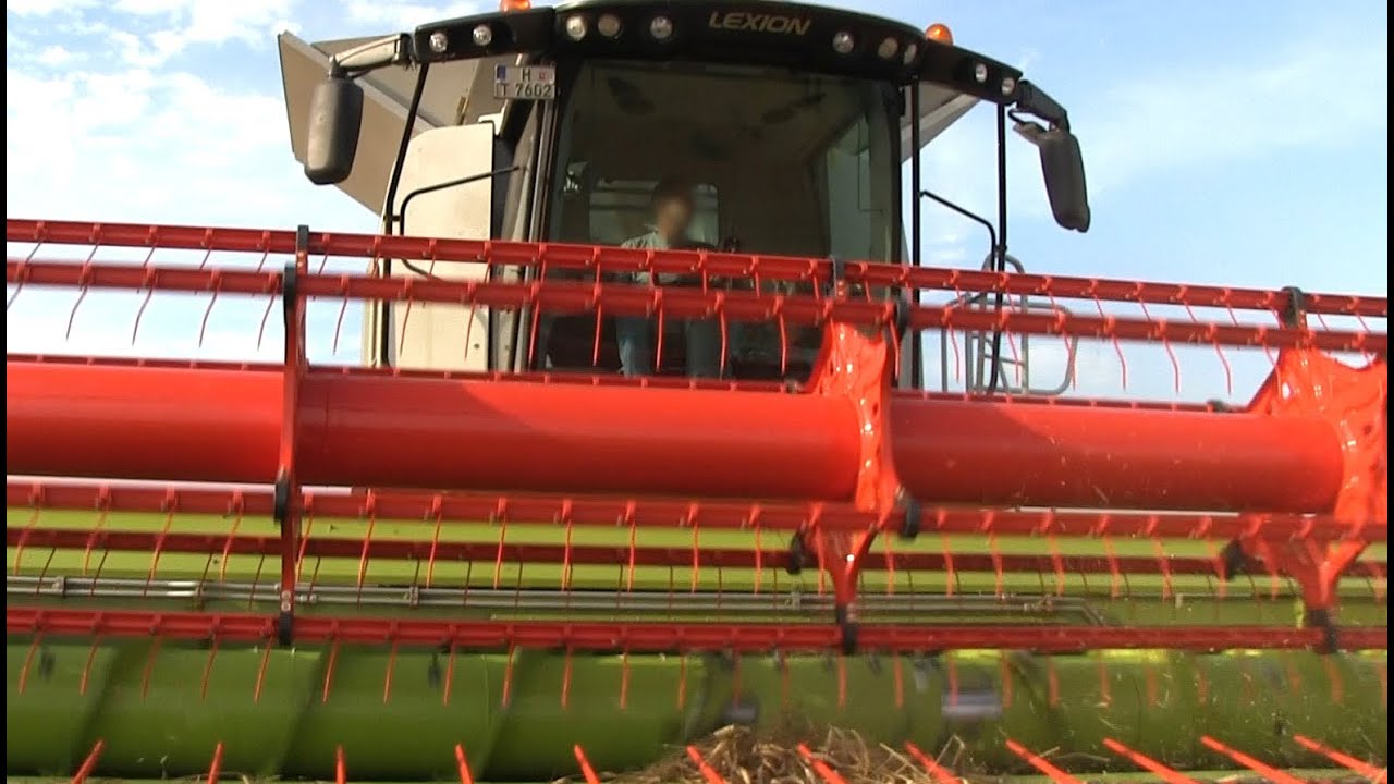 Claas Lexion 760 Mähdrescher (neue Baureihe) und HAWE-Überladewagen