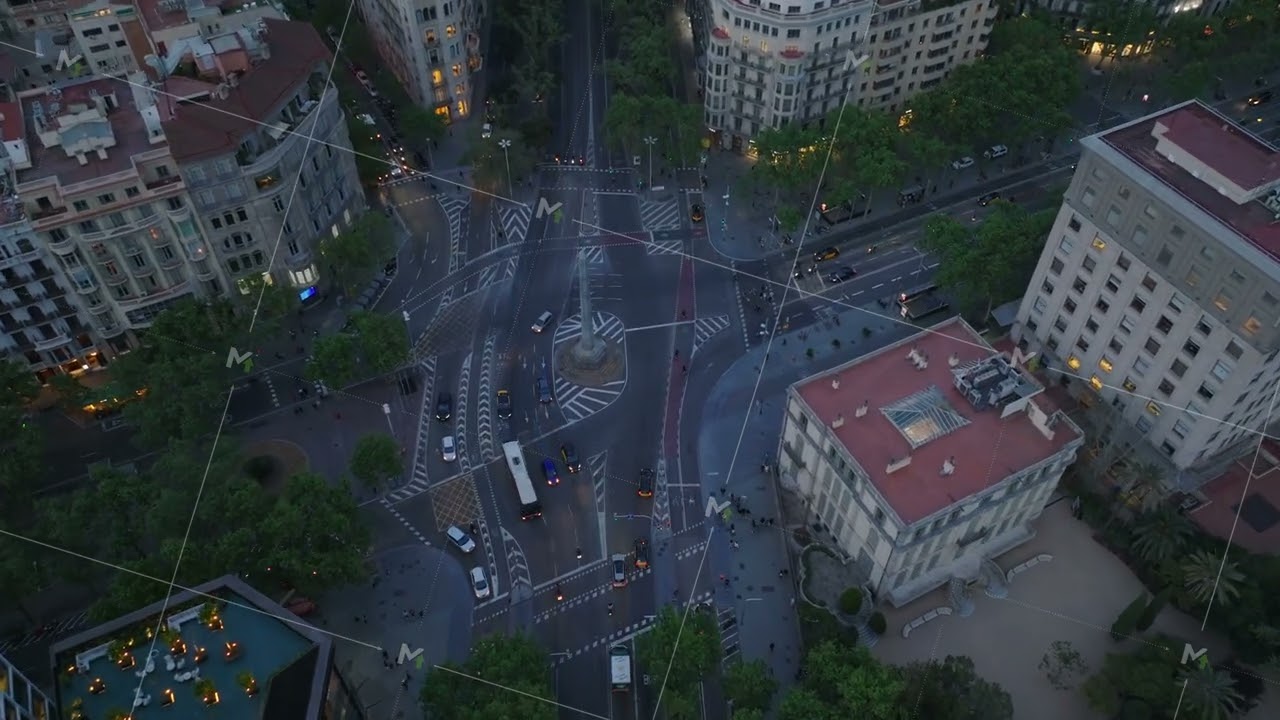 Aerial footage of traffic on road intersection around tall Obelisco de Barcelona. stone monument in
