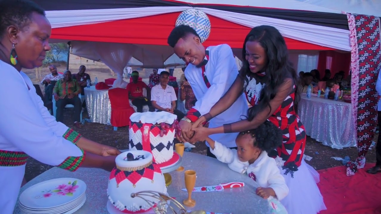 Stephen Kasolo and Grace cake cutting session.