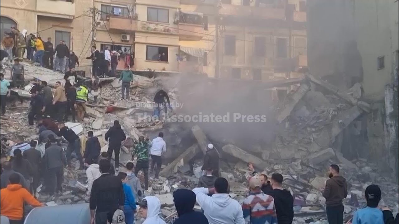 Rescuers search the rubble for survivors after building collapse in northern Lebanon