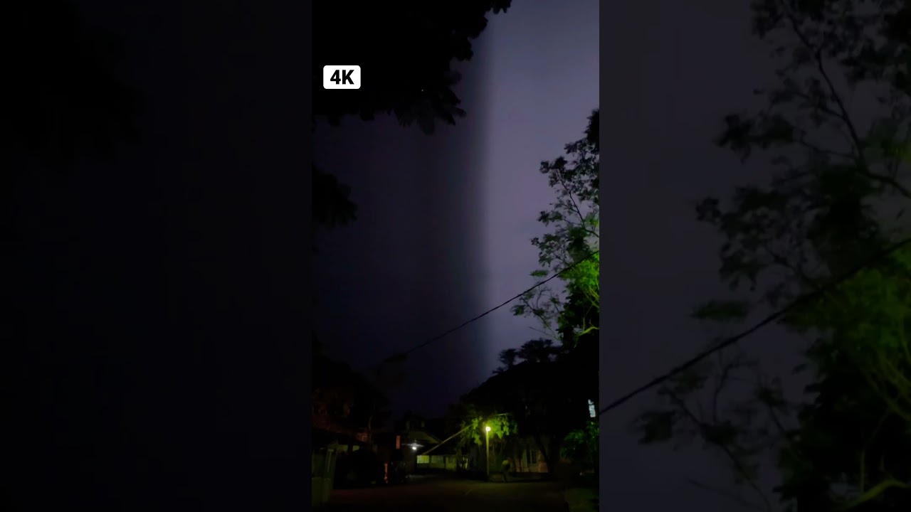 Repeated lightning strikes at night near a hospital sky 4K video static shot 