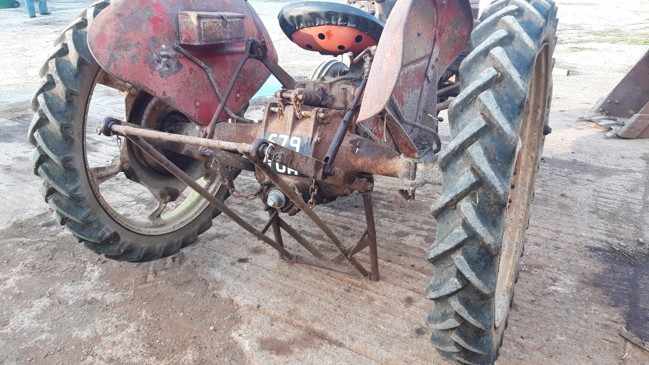 Vintage Thursday. Using a Ferguson tractor jack to change wheels.