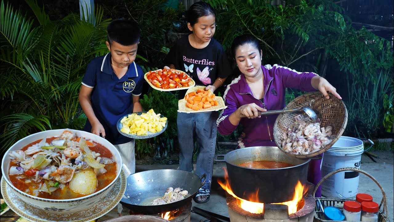 3 country chef cooking together - Seafood Tom yum soup cooking