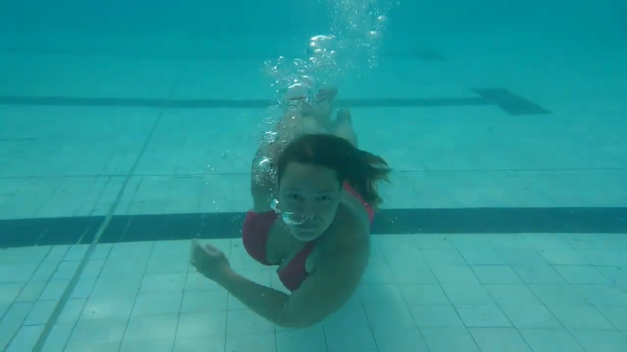 Lady in red with many underwater moves