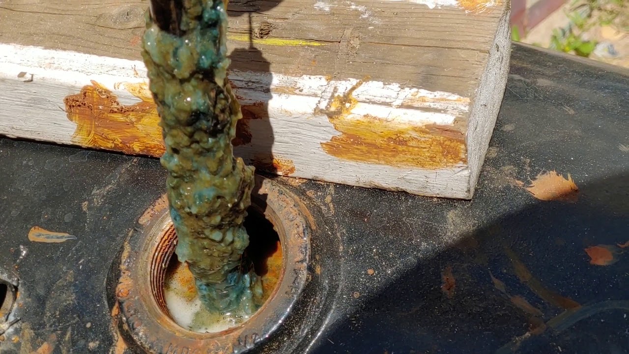 Cleaning rust out of a tank.