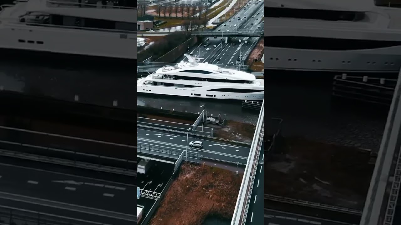 Superyacht ARROW moving through the Dutch countryside and traversing the Gouwe Aquaduct 🚘 🛥