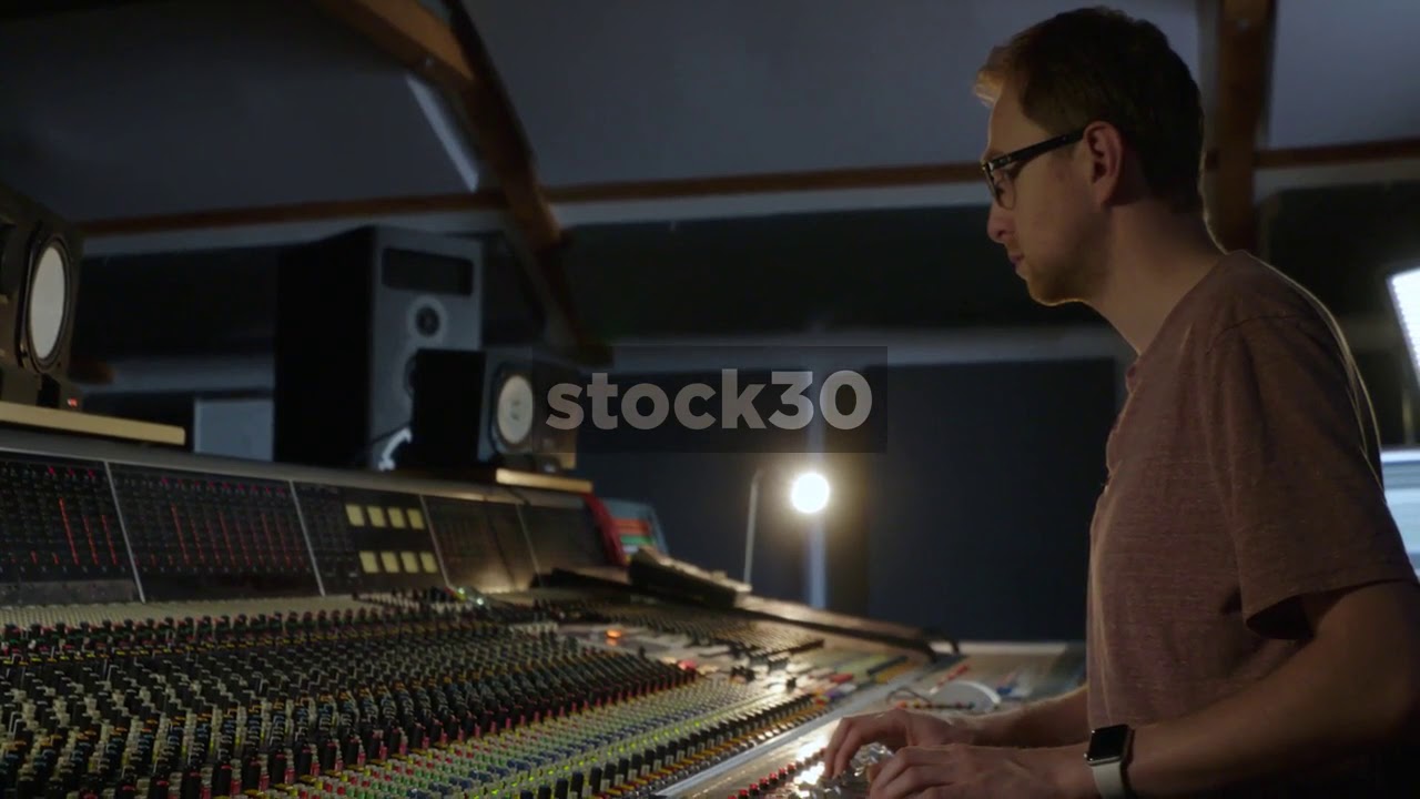 Man In Recording Studio Mixing With Neve VR Legend Analog Console