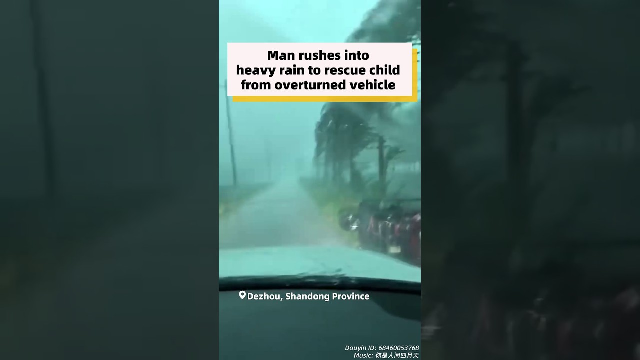 Man rushes into heavy rain to rescue child from overturned vehicle