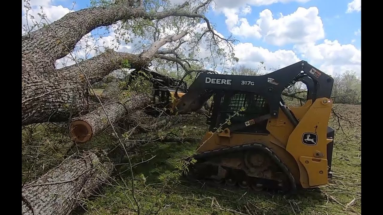 Cleaning up a down tree with a John Deere 317g Track Loader