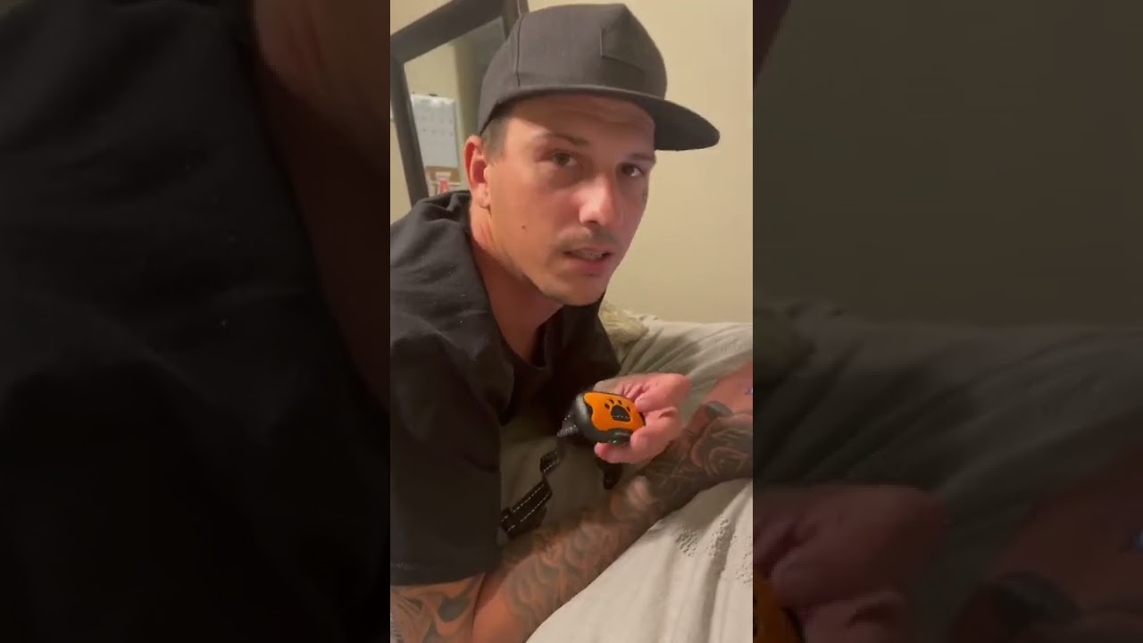 Man tries on the bark collar before using it on their dog...