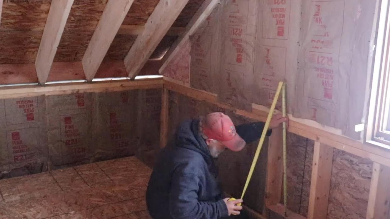Wrapping up the wall insulation on the Alaska cabin