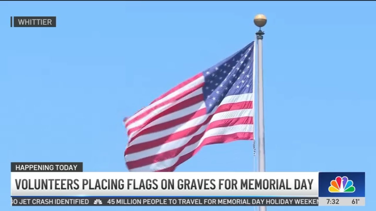 Volunteers place American flags on graves for Memorial Day