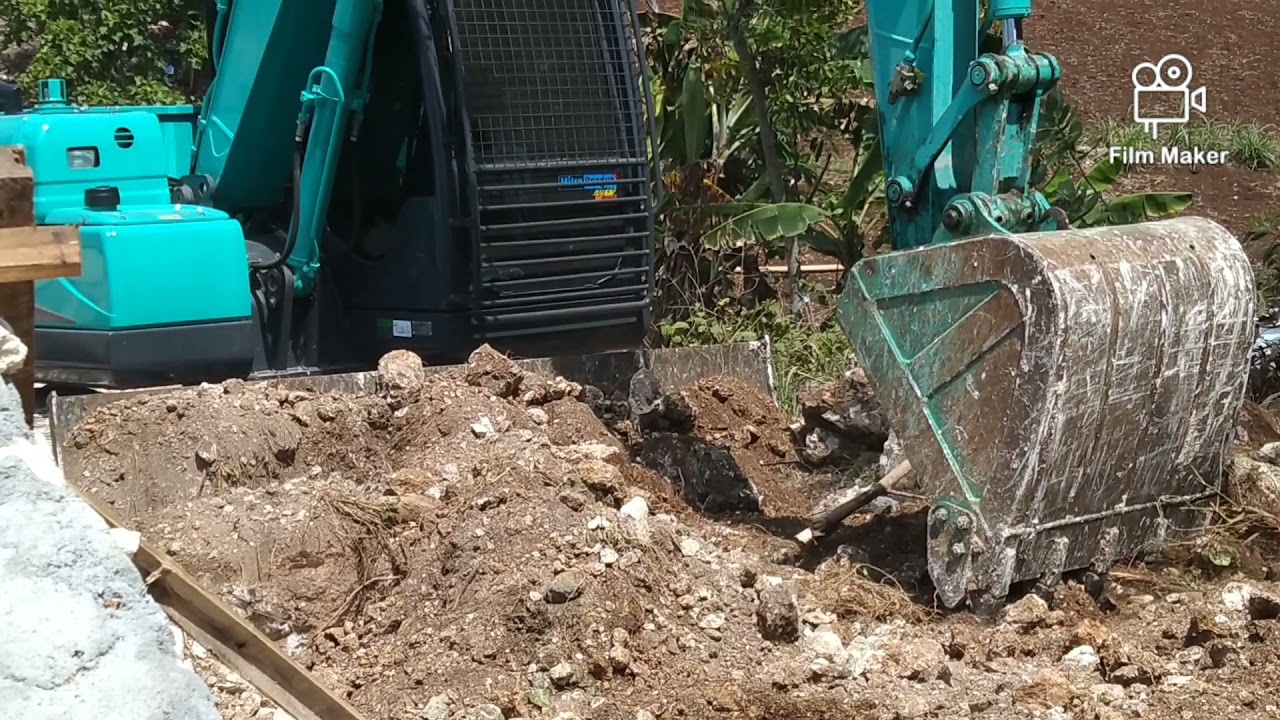 Kobelco -11 SK 75 working on the slopes of the mountain d by the coast