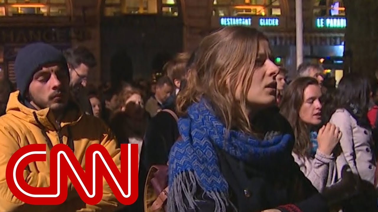Hear crowds sing hymns outside Notre Dame