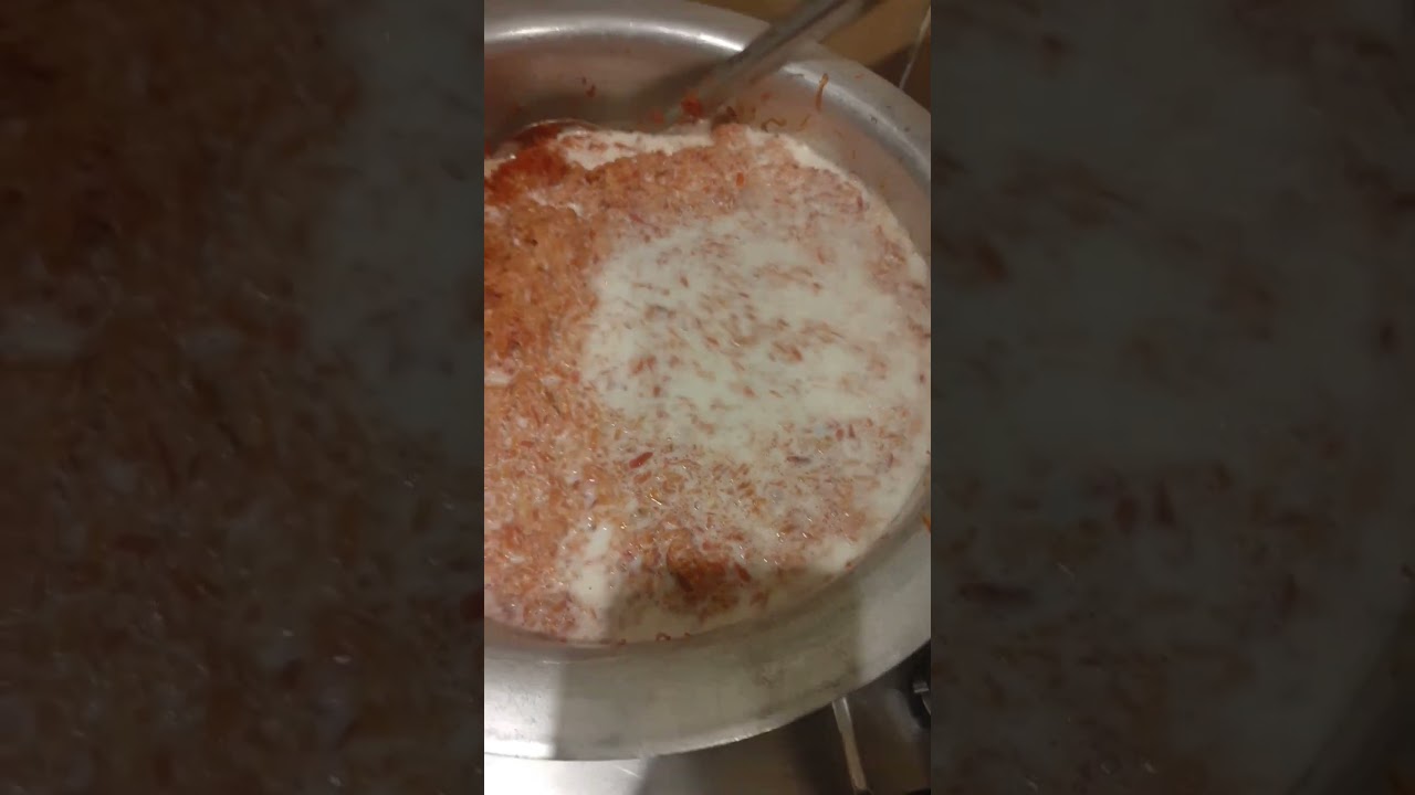 adding milk in gajar halwa.