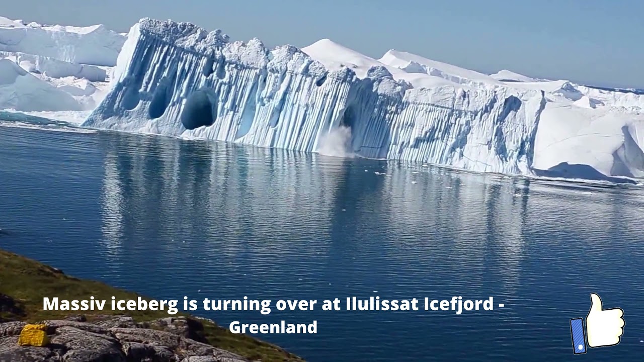 Incredible moment when an iceberg flips over in Greenland